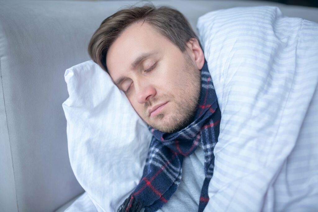 Bearded man sleeping while having high body temperature
